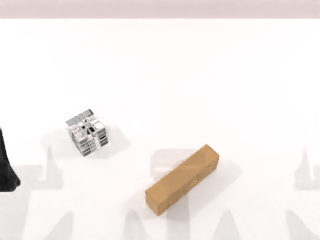 A cube and wooden block on the dual-arm robot's table