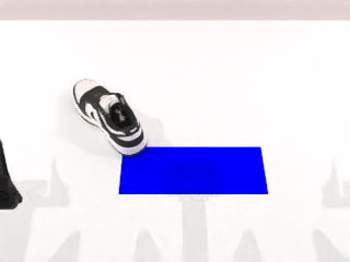 A shoe and blue mat in the robot workspace